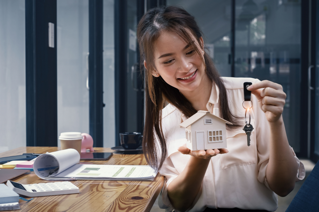 Happy Woman Holding a House Key